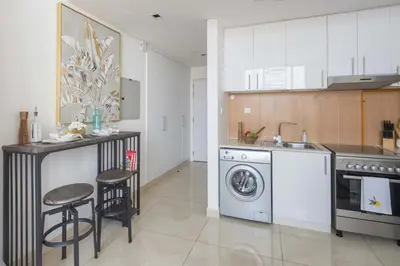 a kitchen with a sink and a washing machine at Frank Porter - Square Tower in Dubai
