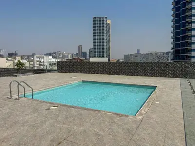 a swimming pool on the roof of a building at Frank Porter - Square Tower in Dubai