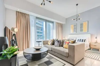 a living room with a couch and a table at Bright & Serene Flat in the Marina, by Only Stays in Dubai