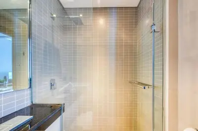 a bathroom with a shower with a glass door at Bright & Serene Flat in the Marina, by Only Stays in Dubai