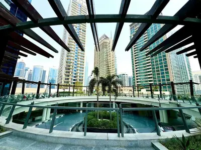a building with a pool in the middle of a city at Bright & Serene Flat in the Marina, by Only Stays in Dubai