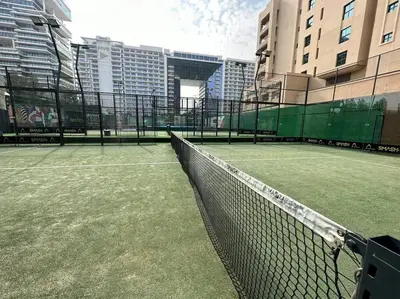a tennis court in the middle of a city at Luxury Palm with Billiard, PingPong table and Beach for 4 in Dubai