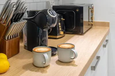 two cups of coffee sitting on a kitchen counter at Luxury Palm with Billiard, PingPong table and Beach for 4 in Dubai