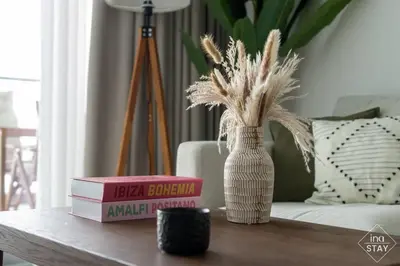 a table with two books and a vase with books at Luxury Palm with Billiard, PingPong table and Beach for 4 in Dubai