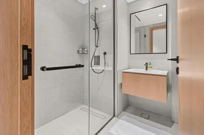 a bathroom with a shower and a sink at Waves - Chic High-Floor Studio Retreat with Canal Views in Dubai