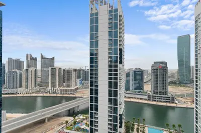 a view of a city skyline with a tall building at Waves - Chic High-Floor Studio Retreat with Canal Views in Dubai