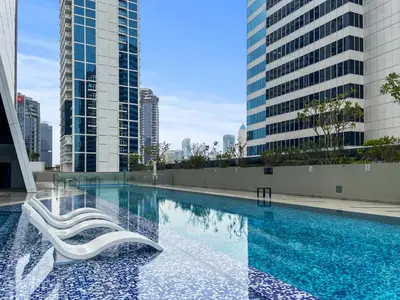 a swimming pool in a city with tall buildings at Waves - Chic High-Floor Studio Retreat with Canal Views in Dubai