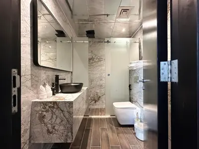 a bathroom with a toilet and a sink at 3-BDR Marina Gem w Stunning Yacht Bay Views in Dubai