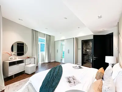 a large bedroom with a white bed and a couch at 3-BDR Marina Gem w Stunning Yacht Bay Views in Dubai