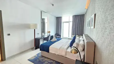 a bedroom with a bed and a large window at Royalton - Damac Maison Prive in Dubai
