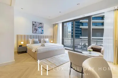 a bedroom with a bed and a large window at LUX The Silverene Marina View Studio 1 in Dubai