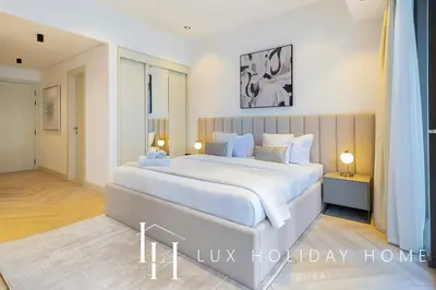 a bedroom with a large bed in a room at LUX The Silverene Marina View Studio 1 in Dubai
