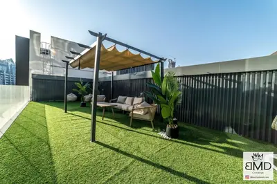 a roof garden with a pergola on a building at Mordern Burj khalifa View 2bd in Dubai