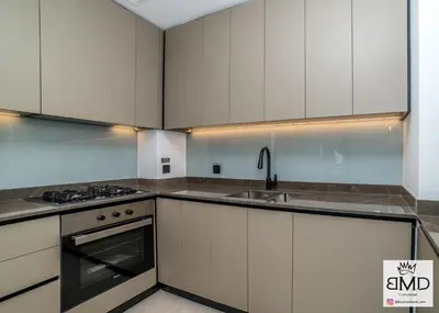 a kitchen with white cabinets and a sink at Mordern Burj khalifa View 2bd in Dubai