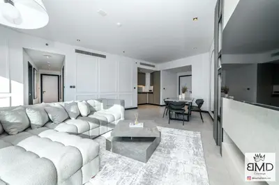 a living room with a white couch and a table at Mordern Burj khalifa View 2bd in Dubai