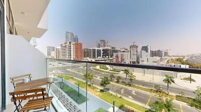 a balcony with a bench and a view of a city at Azizi Riviera 29 - Aesthetic Studio in Meydan in Dubai