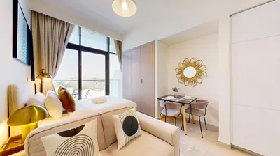 a bedroom with a large bed and a table at Azizi Riviera 29 - Aesthetic Studio in Meydan in Dubai