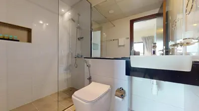 a bathroom with a toilet and a sink and a shower at Locations I Binghatti Gate I Premium Modern 2BR I Skyline & Community Views I Spacious & Comfortable Stay in Dubai