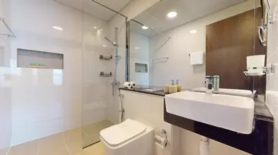 a bathroom with a sink and a toilet and a shower at Locations I Binghatti Gate I Premium Modern 2BR I Skyline & Community Views I Spacious & Comfortable Stay in Dubai