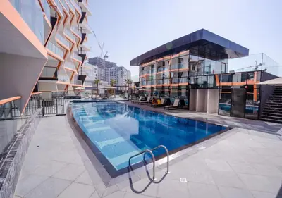 a swimming pool on the roof of a building at Locations I Binghatti Gate I Premium Modern 2BR I Skyline & Community Views I Spacious & Comfortable Stay in Dubai