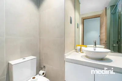 a bathroom with a white toilet and a sink at Studio One - Dubai Marina - Pool, Sauna, Hammam and Gym in Dubai