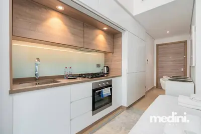 a kitchen with a sink and a stove top oven at Studio One - Dubai Marina - Pool, Sauna, Hammam and Gym in Dubai