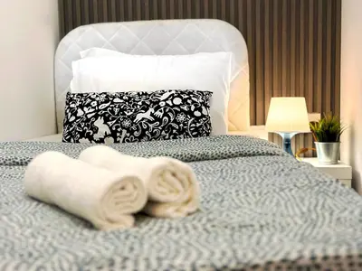 a bedroom with a bed with towels on it at Radiant Parition Room in Barsha Heights Near Metro in Dubai