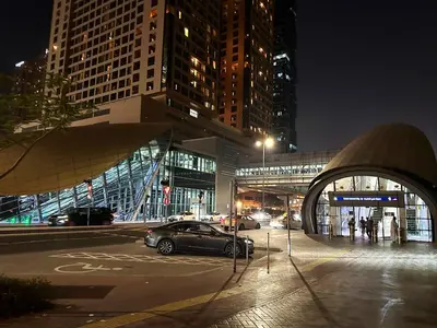 a car parked in a parking lot in a city at night at Radiant Parition Room in Barsha Heights Near Metro in Dubai