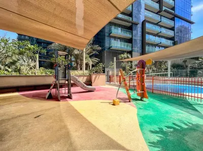a playground in a building with a swimming pool at Dubai Marina 1BR with Pool Near Shops & Restaurants in Dubai
