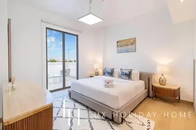 a bedroom with a bed and a large window at LUX The Elegant Sea View Suite in Dubai
