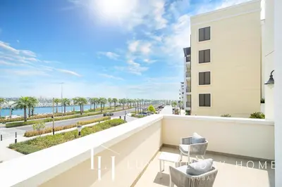 a balcony with a view of the ocean at LUX The Elegant Sea View Suite in Dubai