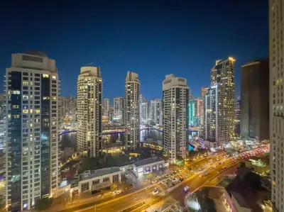a city skyline at night with a lot of traffic at FIRST CLASS 2BR Luxurious Escape in Dubai
