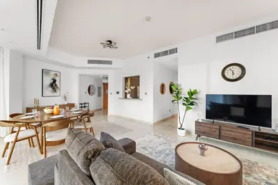 a living room with a couch and a table at FIRST CLASS 2BR Luxurious Escape in Dubai