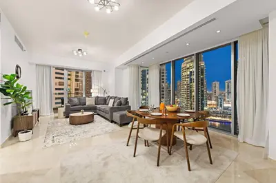 a living room with a table and a couch at FIRST CLASS 2BR Luxurious Escape in Dubai