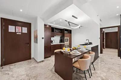 a kitchen and dining room with a table and chairs at FIRST CLASS 2BR Premium City Escape in Dubai
