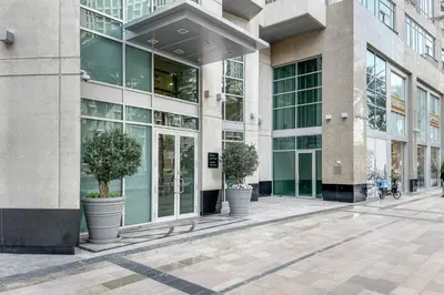 a building with two potted trees in front of it at Blueground Downtown BK view pool gym DXB-130 in Dubai