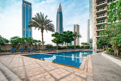 a swimming pool in a city with tall buildings at Blueground Downtown BK view pool gym DXB-130 in Dubai