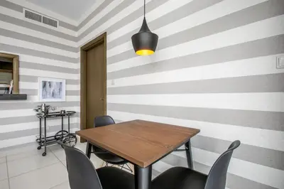 a dining room with a wooden table and chairs at Blueground Downtown BK view pool gym DXB-130 in Dubai
