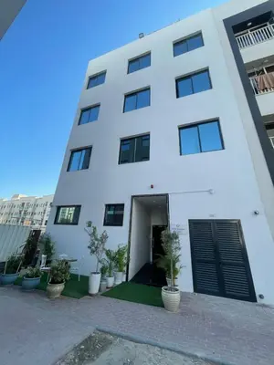 a white building with plants in front of it at Ista Vacation Homes LLC in Dubai