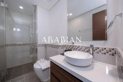a bathroom with a sink and a shower and a toilet at Cozy 1BR Apartment with Balcony in Business Bay in Dubai