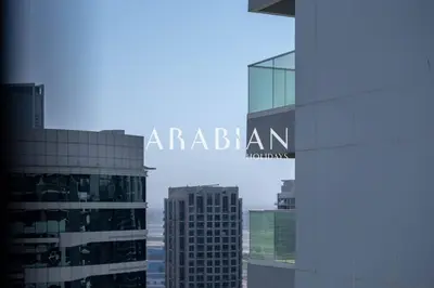 a view of a city with the words australian on a building at Cozy 1BR Apartment with Balcony in Business Bay in Dubai