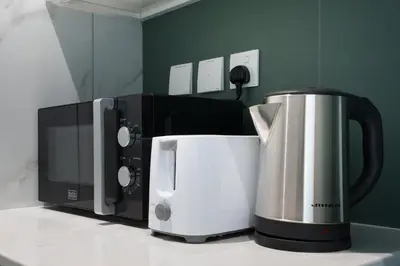a coffee maker and a microwave on a counter at Stylish Studio Near Dubai Academic City in Dubai