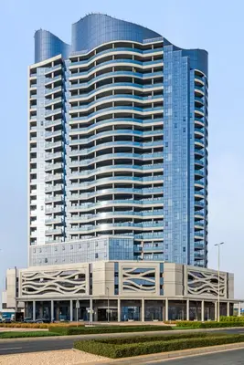 a large building with a lot of windows at Stylish Studio Near Dubai Academic City in Dubai