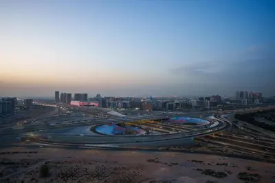 a large highway with a city in the background at Stylish Studio Near Dubai Academic City in Dubai