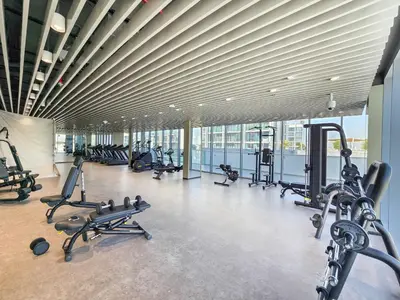 a gym with several treadmills and cardio machines at Amazing 2BDR with Lagoon view in District One 13 Al Merkadh in Dubai