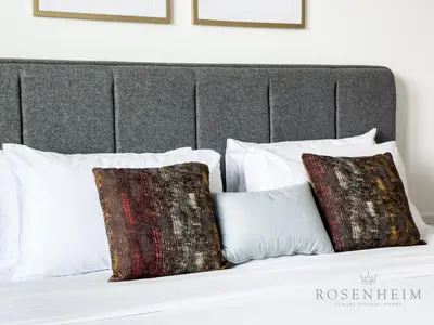 a bed with two pillows on top of it at Elevated Living at The Bay - Canal & Khalifa Views in Dubai
