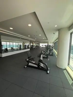 a gym with treadmills and ellipticals in a building at Elevated Living at The Bay - Canal & Khalifa Views in Dubai
