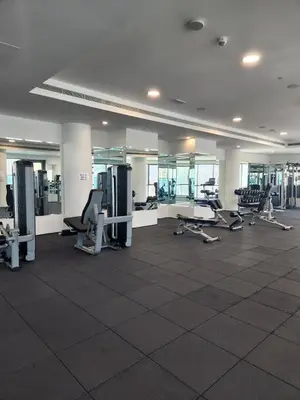 a large room with a gym with treadmills and machines at Elevated Living at The Bay - Canal & Khalifa Views in Dubai