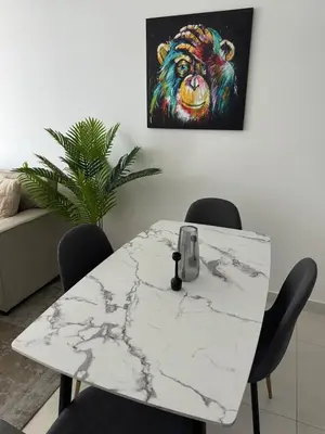 a white marble table with a painting of a bear at Brand New JVC 1 bed - sleeps 4 in Dubai