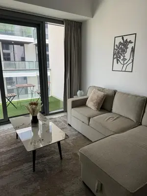 a living room with a couch and a coffee table at Brand New JVC 1 bed - sleeps 4 in Dubai